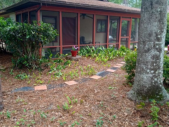 Front porch with pathway to side yard