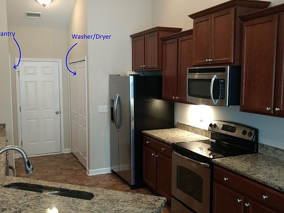 Well-appointed kitchen with granite countertops and stainnless steel appliances