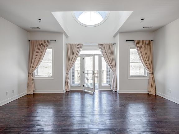 Dramatic Art Deco architecture with soaring ceilings and signature round window - Living room