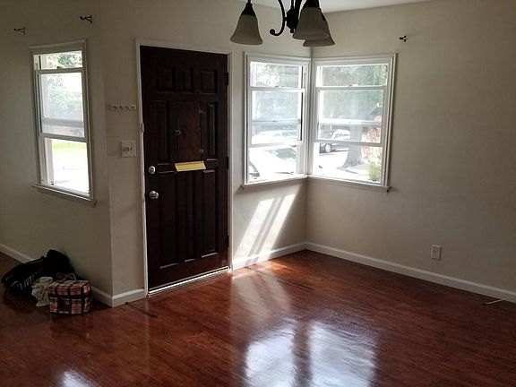Living room area with beautiful refinished hardwood floors 