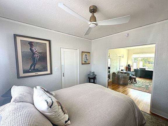 Primary bedroom/living room suite with door to large walk-in closet/laundry room