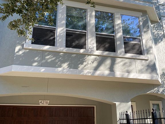 3 story townhome with small courtyard and 4 spots parking in driveway