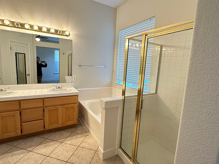 Master bathroom with bathtub and standing shower