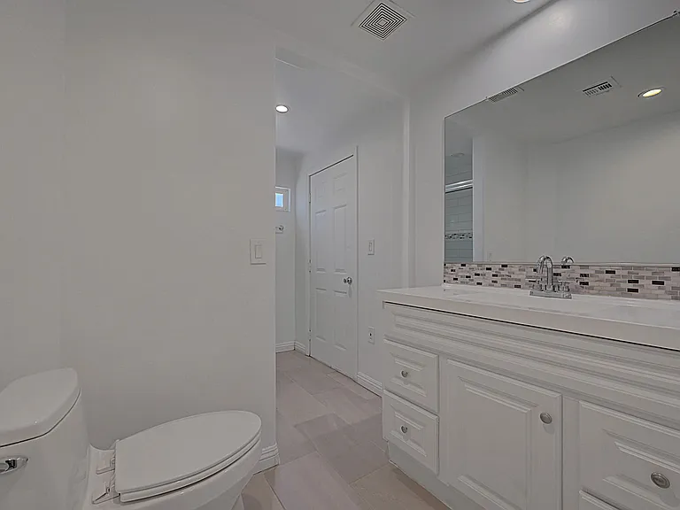 Spacious updated bathroom with oversized vanity and modern finishes
