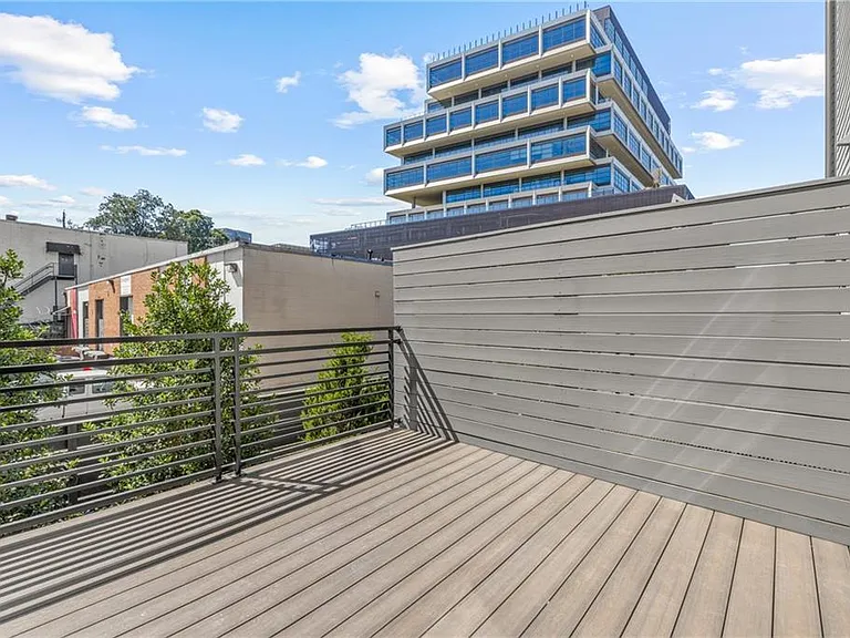 Back Patio (Note: Actual unit has light wooden floors and upgraded fixtures / appliances)