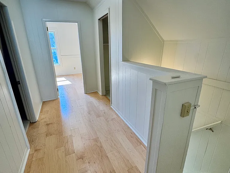 Landing at the top of the stairs with two large hall closets