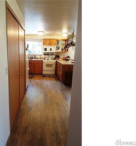As you enter, you see the large kitchen with all new updated wood laminate flooring.