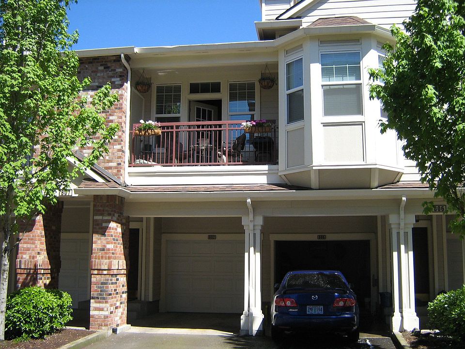 Garage on the right with master bedroom windows above. Balcony to the left.