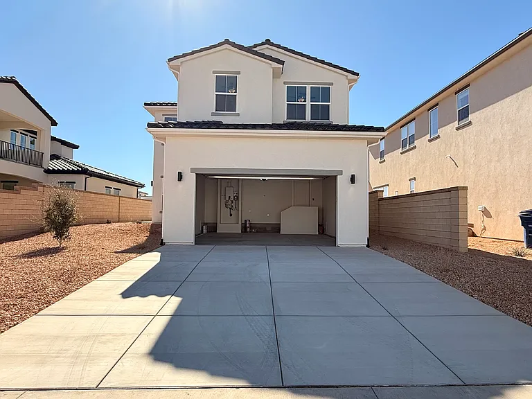 View of oversized garage and extra large driveway