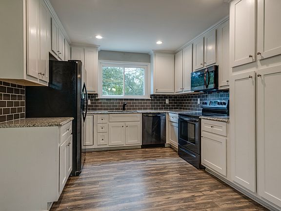 Granite countertops, custom cabinets and black stainless appliances make everyday cooking a pleasure.