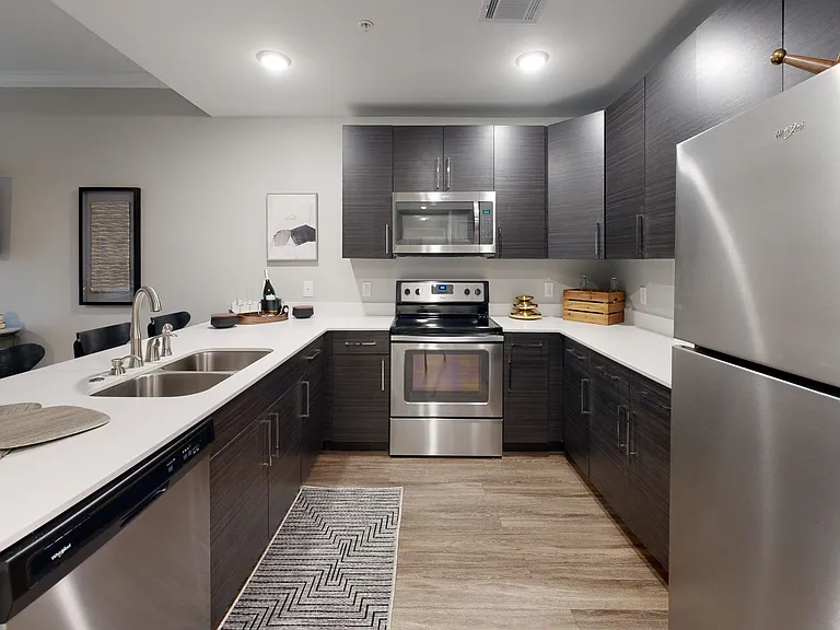 The kitchen includes a double sink, dishwasher, glasstop stove, and microwave. The kitchen includes a double sink, dishwasher, glasstop stove, and microwave.
