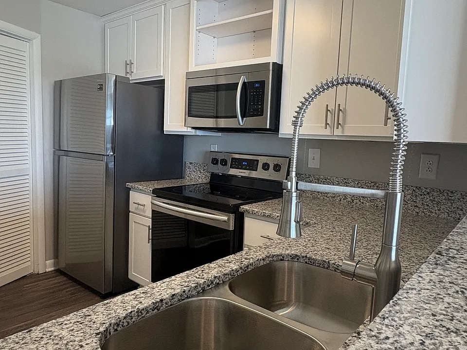 Beautiful modern kitchen with granite counter tops and chefs faucet