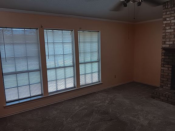 Den/family room with natural lighting, vaulted ceiling, all brick wood burning fireplace with hearth & mantle, plush carpet. Perfect place to relax and enjoy family & friends.