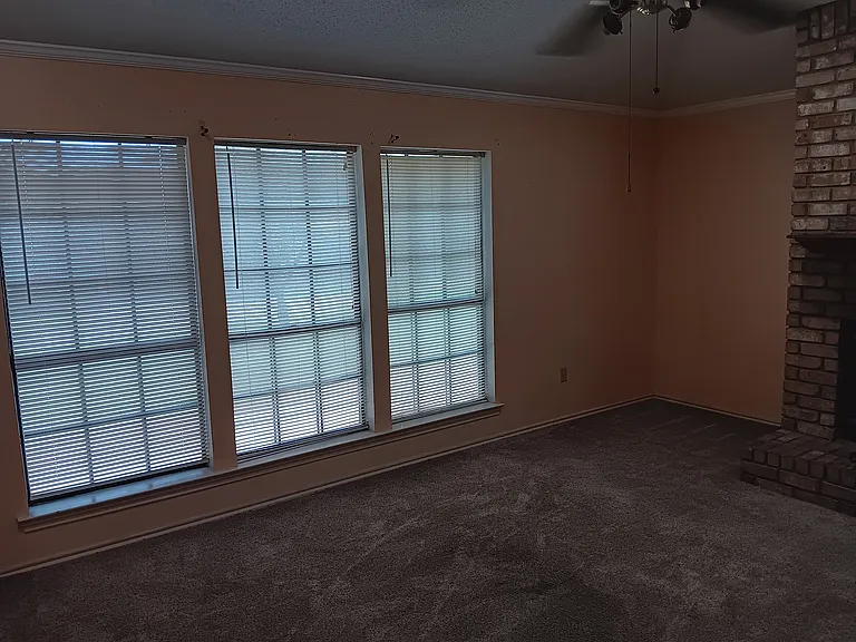 Den/family room with natural lighting, vaulted ceiling, all brick wood burning fireplace with hearth & mantle, plush carpet. Perfect place to relax and enjoy family & friends.