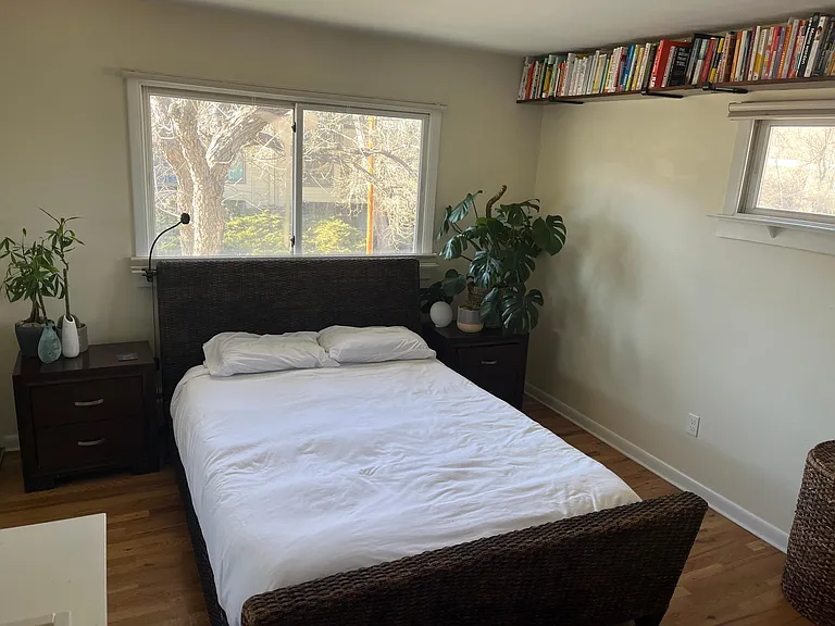 Master bedroom with wrap around bookshelf