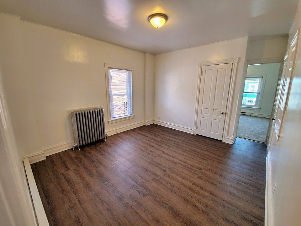 Living room, which has three large closets. Entry to front bedroom in right of frame.