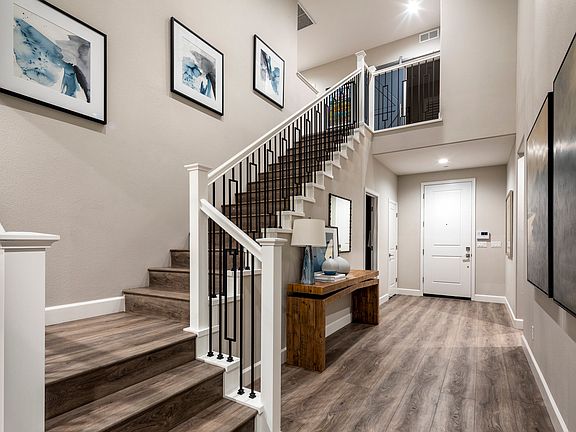 Foyer with ample space for furniture and staircase with optional iron balusters
