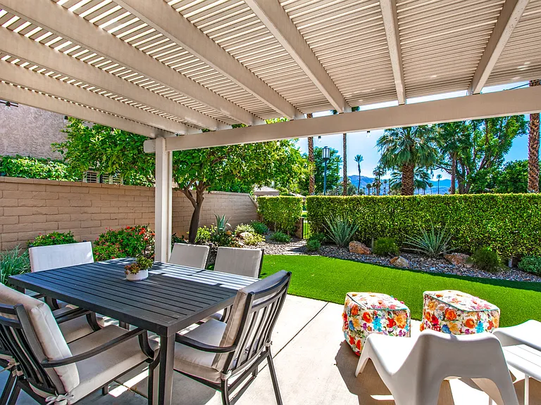 Outdoor patio with mature orange tree. Gardener included