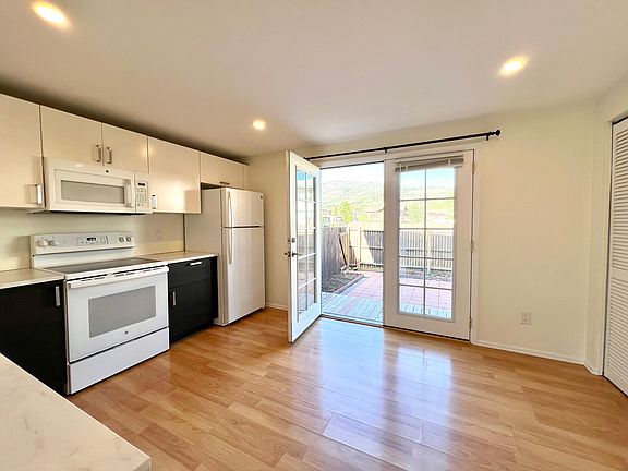 Kitchen with double doors to the Backyard.