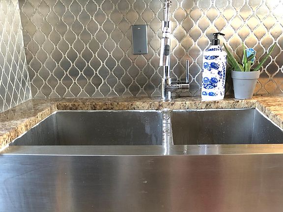 Huge farmhouse sink with custom backsplash