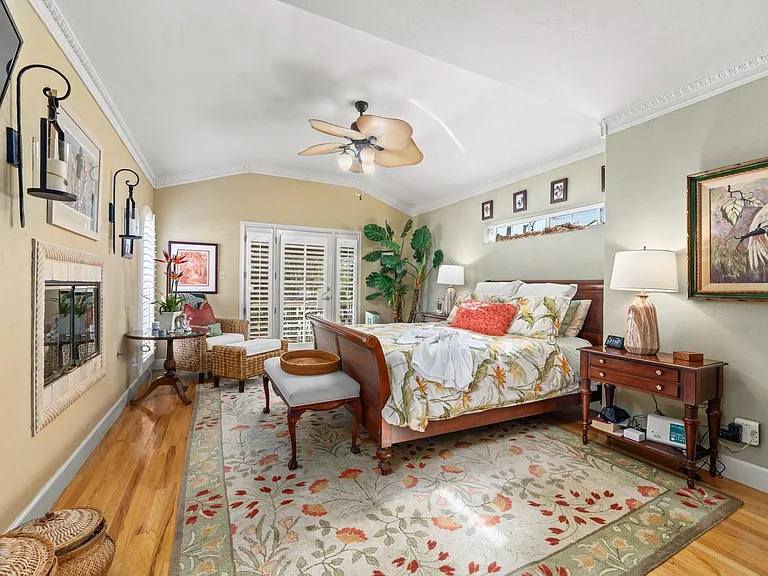 Primary bedroom with king-sized bed, TV and fireplace