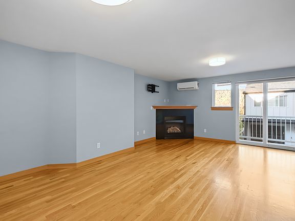 Gleaming hardwoods, new lighting, balcony off living room and open floor plan.