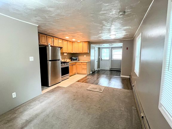 View of entry, eat in kitchen and living room