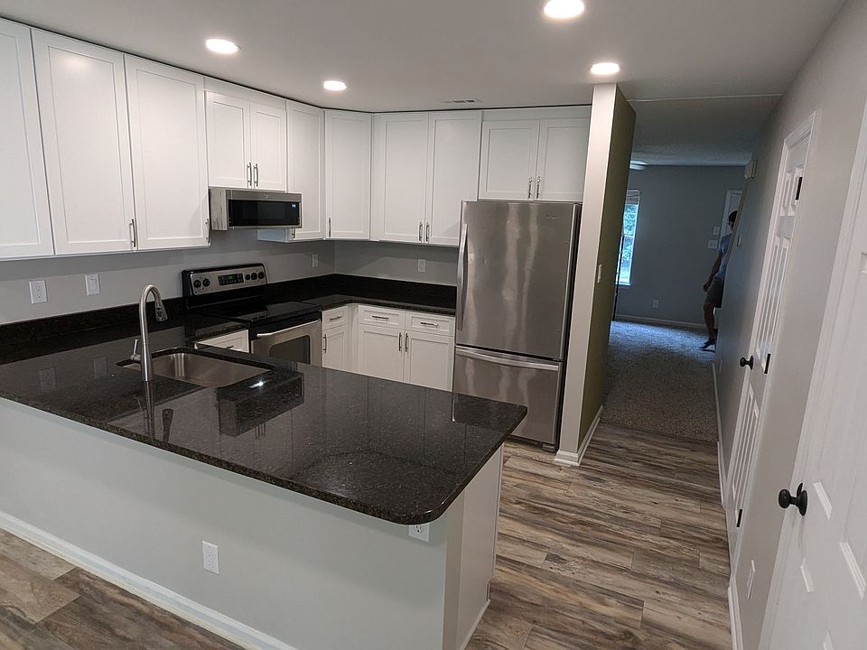 Kitchen includes stainless steel appliances and a dishwasher.