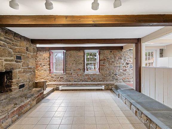 Living area with beautiful stone walls and exposed beams