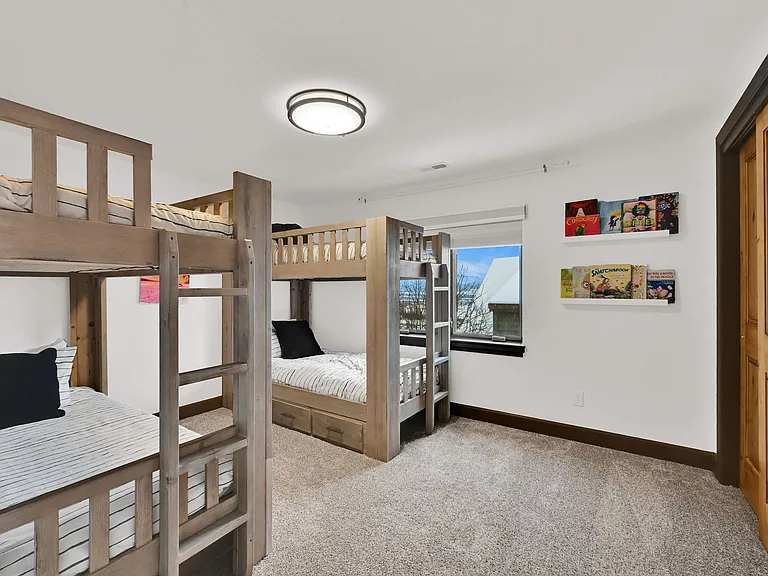 Upstairs bedroom with two bunk beds with full sized mattresses