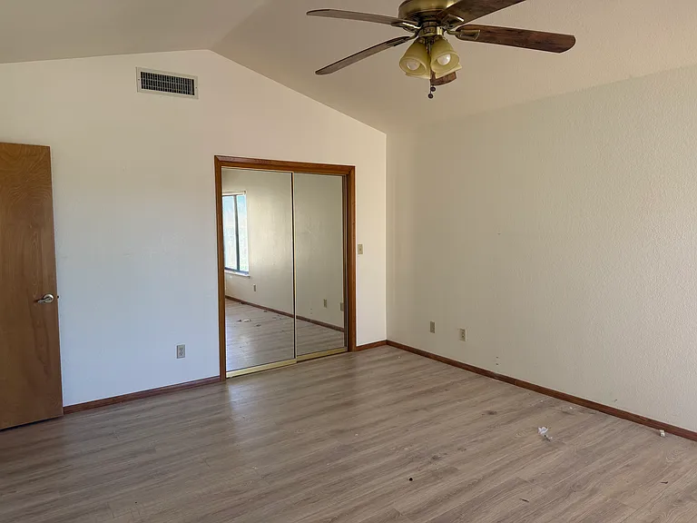 Master bedroom with mirrored walk in closet