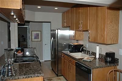 The kitchen has stainless appliances and granite counters with plenty storage.