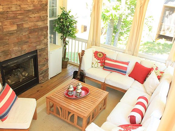 Screened in back porch with fireplace