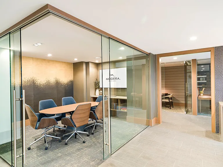A polished conference room at Modera McGavock, offering a professional setting for meetings and focus, with downtown Nashville just minutes away.