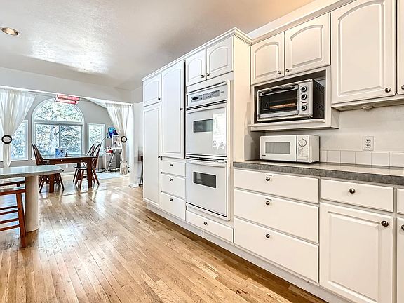 Large kitchen, 2 ovens, toaster oven, air fryer, toaster microwave, large sinks, dishwasher, stove top, new refrigerator, newly updated, hardwood floors, lots of cupboard space. Dining room and 2 tables. Newly remodeled, new appliances