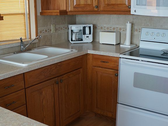 Remodeled kitchen. New cabinets, countertops, appliances and tile backsplash.