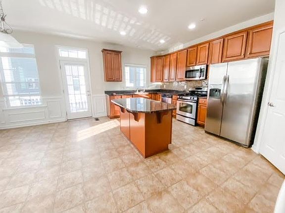 Nice large kitchen with granite counter tops, custom backsplash, custom moldings, stainless steel appliances, glass door to balcony, great dining area that can accommodate a large table for family gatherings