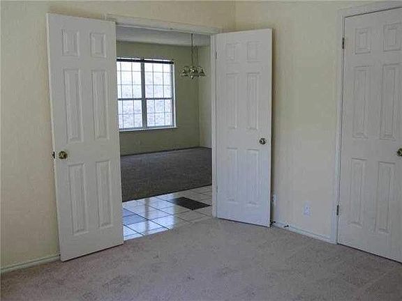Front office with french doors looking into formal dining.
