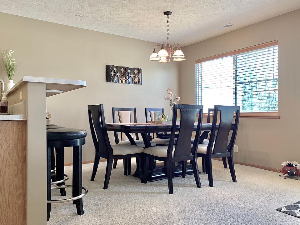 Spacious dining room. Chandelier and large window provide lots of light.
