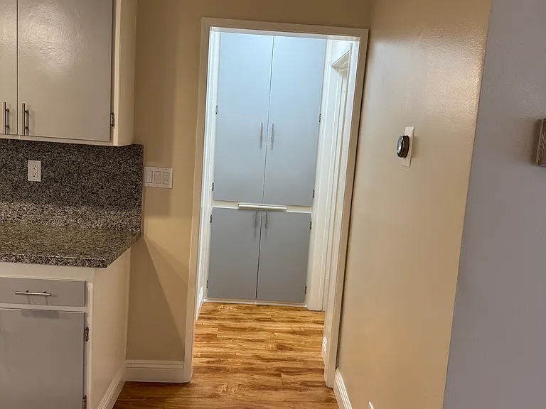 Hallway that leads to bedroom on the right and bathroom on the left. 
Nest on the wall