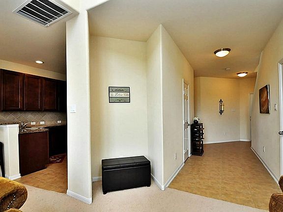 View of the entry way w/half bath to the left and closet for extra storage