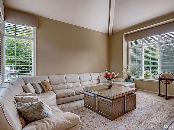 Large formal livingroom with vaulted ceilings, filled with natural light.