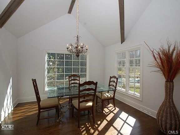 The dining area has a vaulted ceiling and overlooks the pool ...