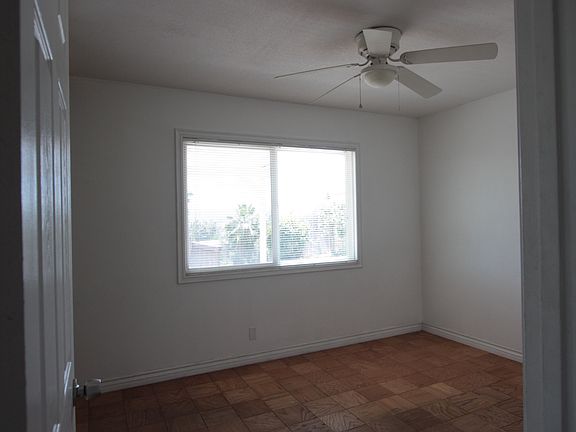 Bedroom with Closet, Ceiling Fan, and View of Backyard.