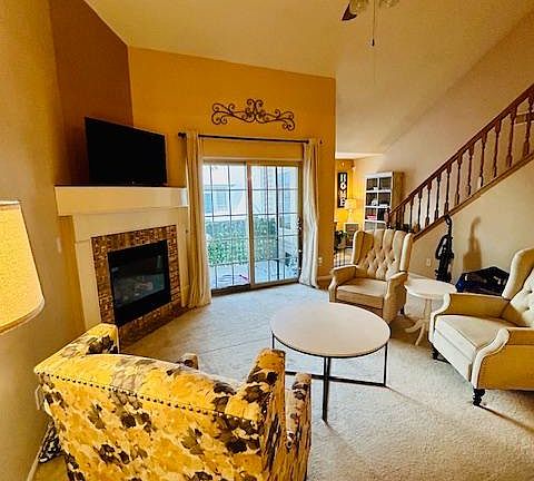 Living Space with tall 25 ft ceiling and gas fireplace