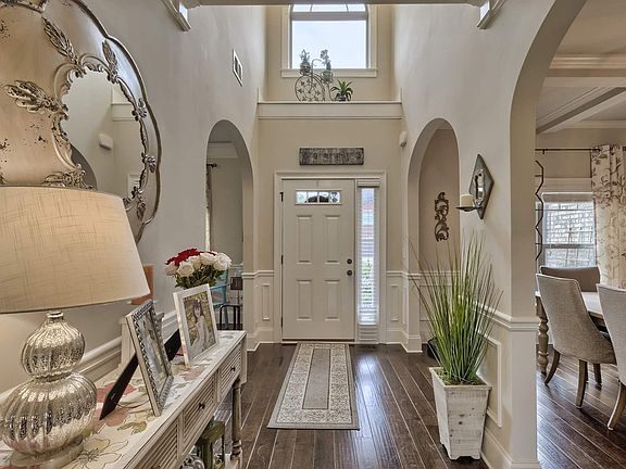 The grand entry features heavy molding and arched doorways.