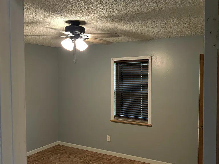 2nd bedroom with solid wood floor, closet, cieling fan and window with upgraded blinds (lift up or pull down by hand and look like wood/are wider/thicker).