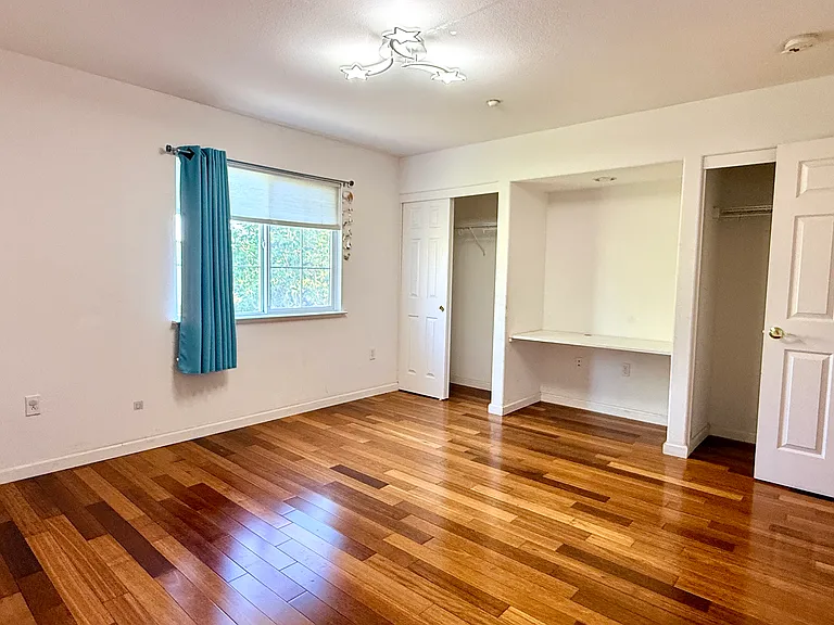 Upstairs bedroom with hardwood floors and spacious closet