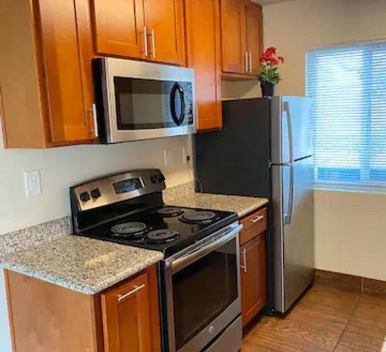 nice, clean kitchen with stainless steel refrigerator, microwave and stove with oven.