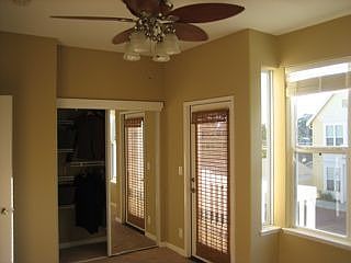 Master with balcony, and great fan/light fixture.